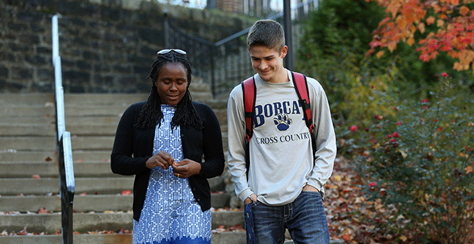 Two students walking and talking together