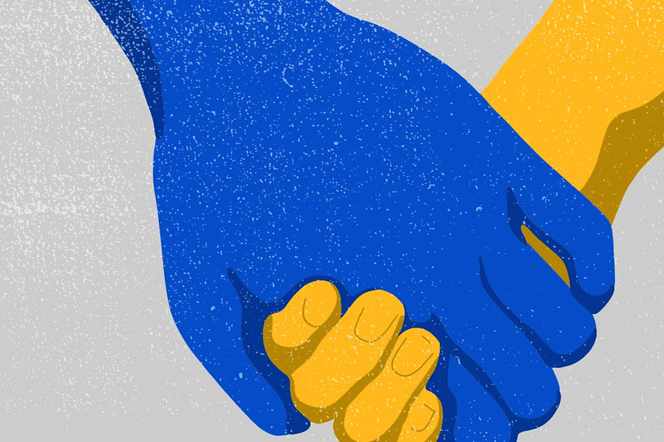 A blue hand and a yellow hand are held together